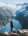 free-photo-of-woman-standing-on-mountain-peak-above-lake-in-alps-near-zillertal-austria.jpeg