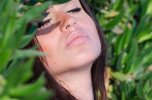 pretty-lady-fleshy-lips-against-bush-wall-long-brunette-hair-leaning-eyes-closed-feeling-sun-h...jpg