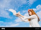 teenage-girl-releasing-white-dove-into-sky-G3HMRB.jpg